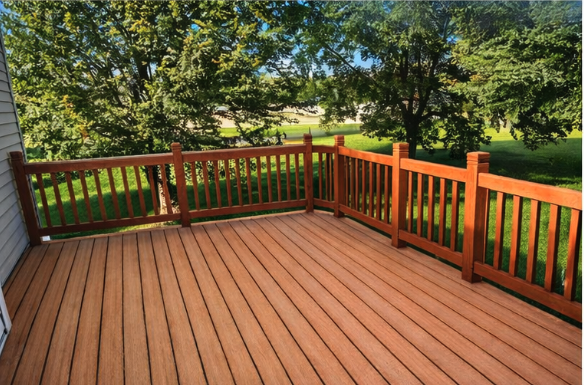 Spacious cedar deck with dark stained railings and lawn views